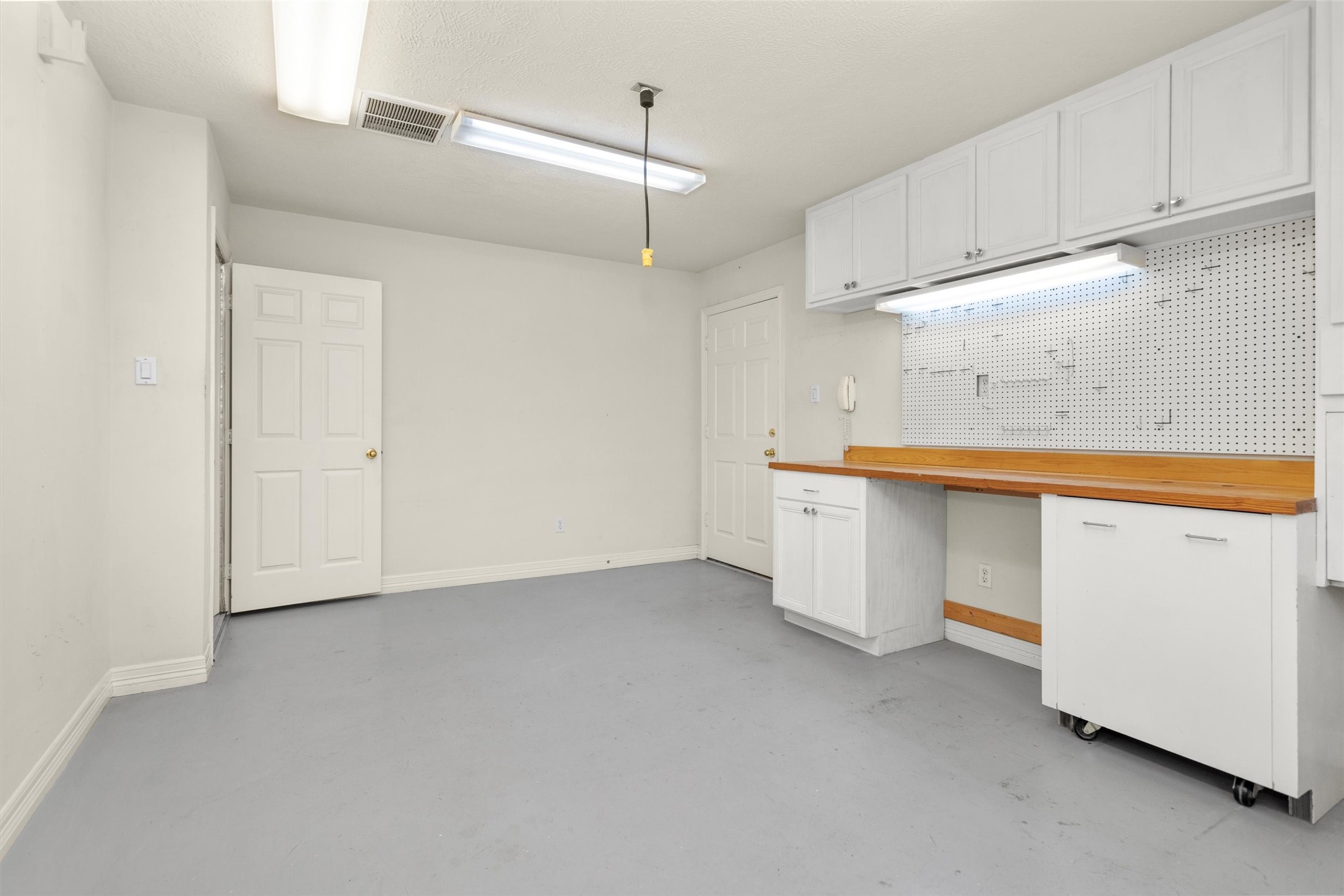 2419 Carriage Ridge Lane Conroe, TX 77384 - Photo 32 of 39 a view of a kitchen with white cabinets and wooden floors
