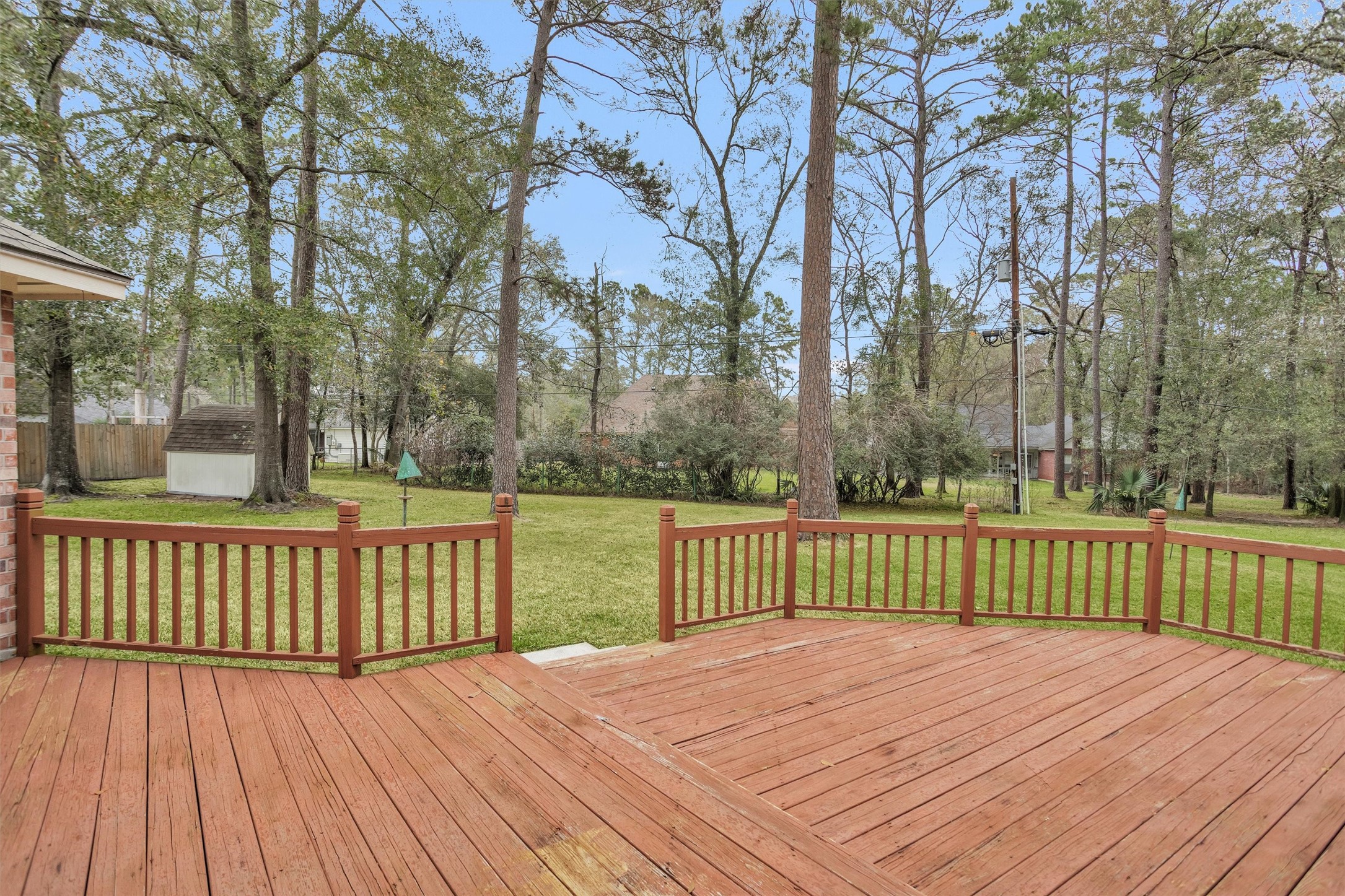 2419 Carriage Ridge Lane Conroe, TX 77384 - Photo 37 of 39 a view of a deck with trees with wooden floor and fence