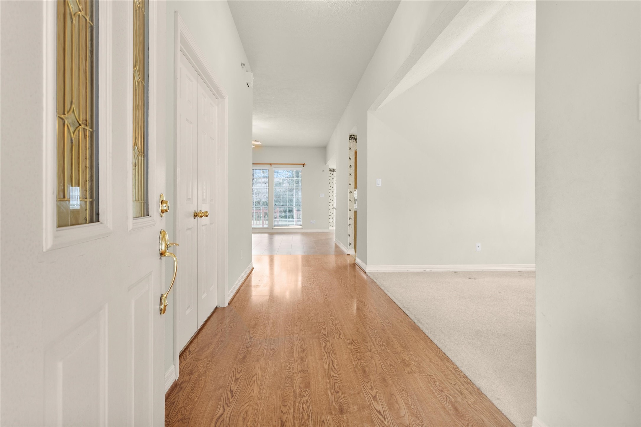 2419 Carriage Ridge Lane Conroe, TX 77384 - Photo 6 of 39 a view of a hallway with wooden floor and staircase