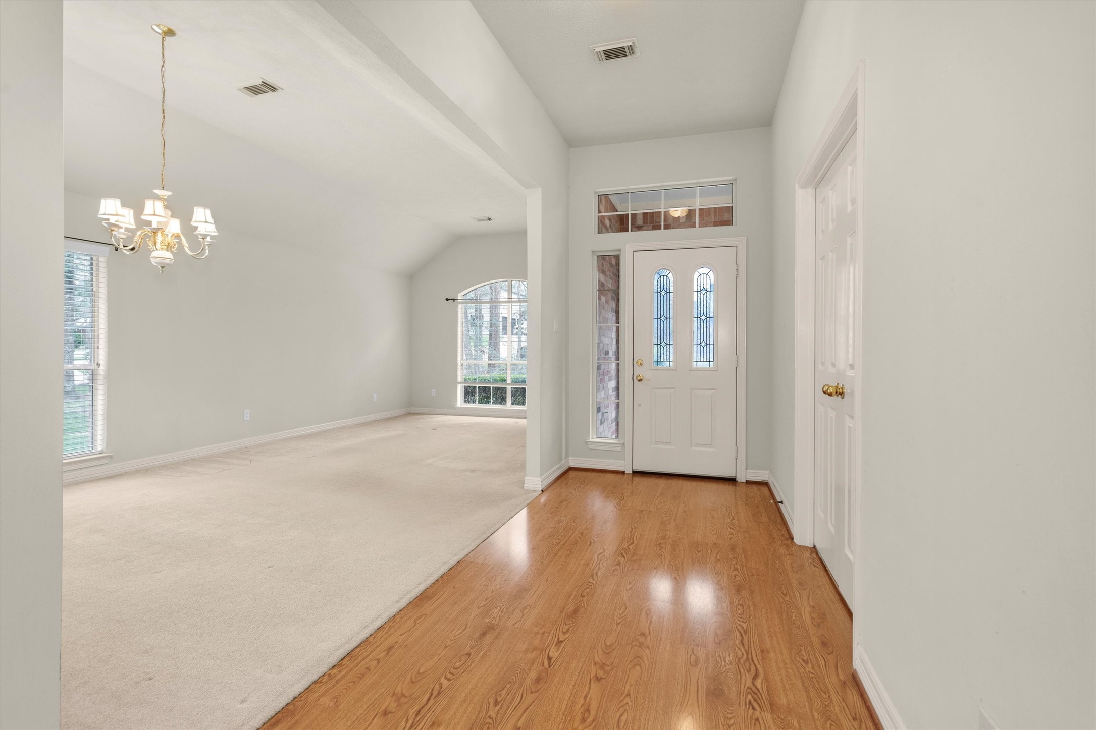 2419 Carriage Ridge Lane Conroe, TX 77384 - Photo 7 of 39 a view of a room with wooden floor and chandelier
