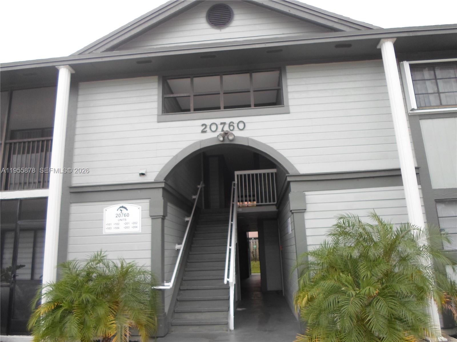 20760 Northeast 4th Court, Unit 201 Miami, FL 33179 - Photo 1 of 55 a view of a house with more windows and plants