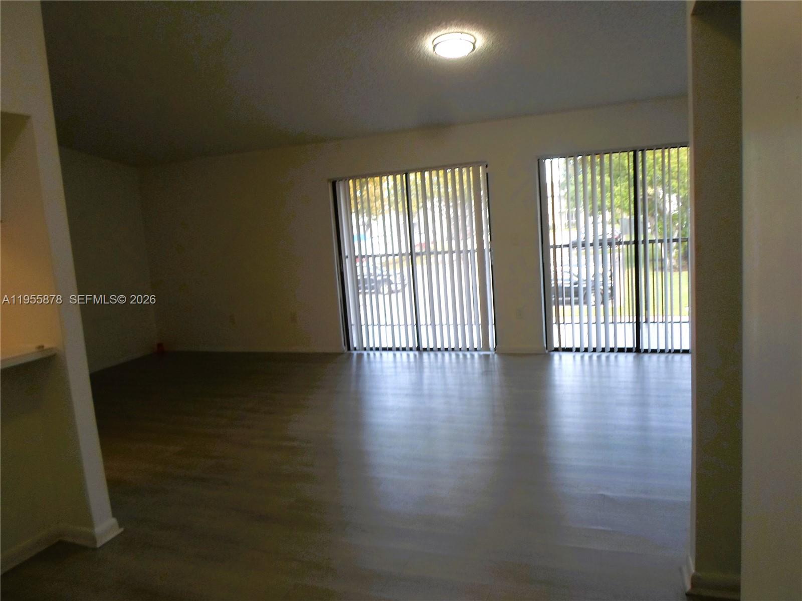20760 Northeast 4th Court, Unit 201 Miami, FL 33179 - Photo 12 of 55 a view of a livingroom with wooden floor and a window