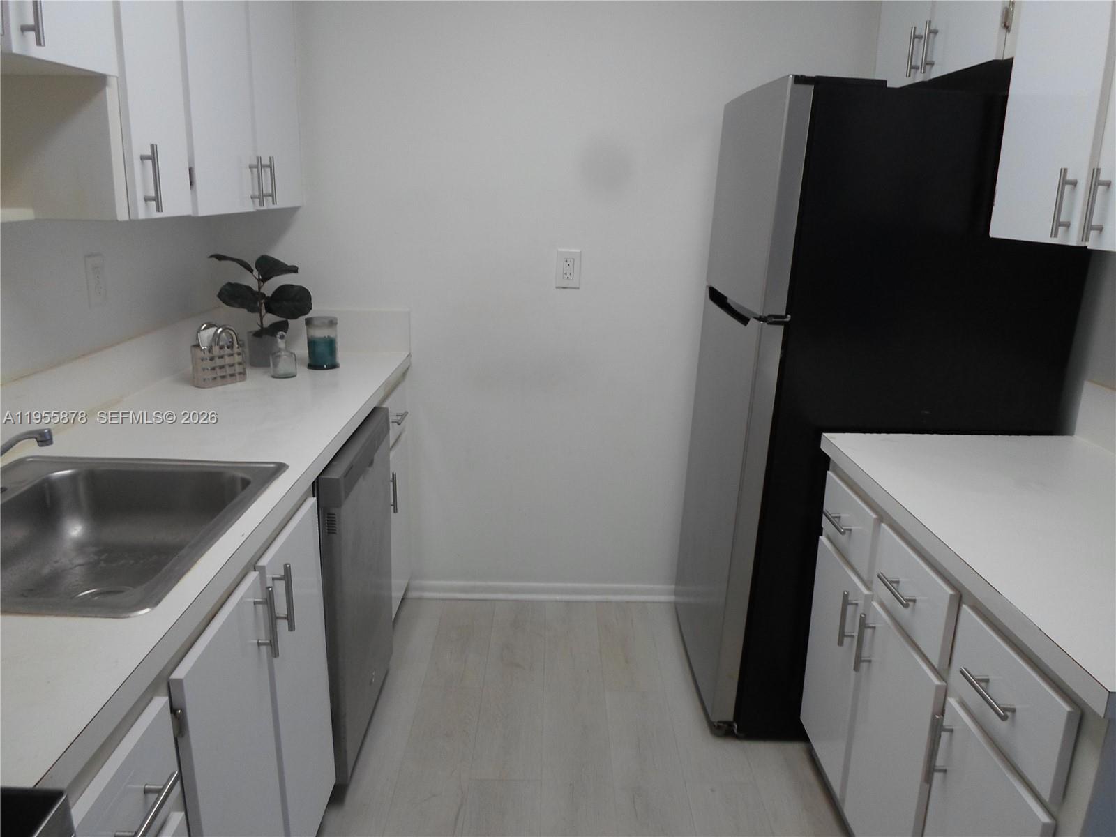 20760 Northeast 4th Court, Unit 201 Miami, FL 33179 - Photo 16 of 55 a kitchen with a sink and cabinets