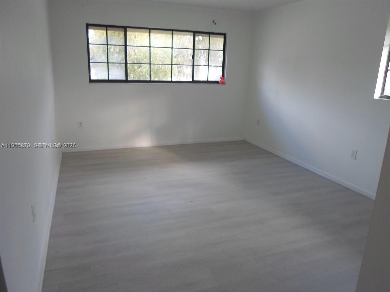 20760 Northeast 4th Court, Unit 201 Miami, FL 33179 - Photo 31 of 55 an empty room with windows