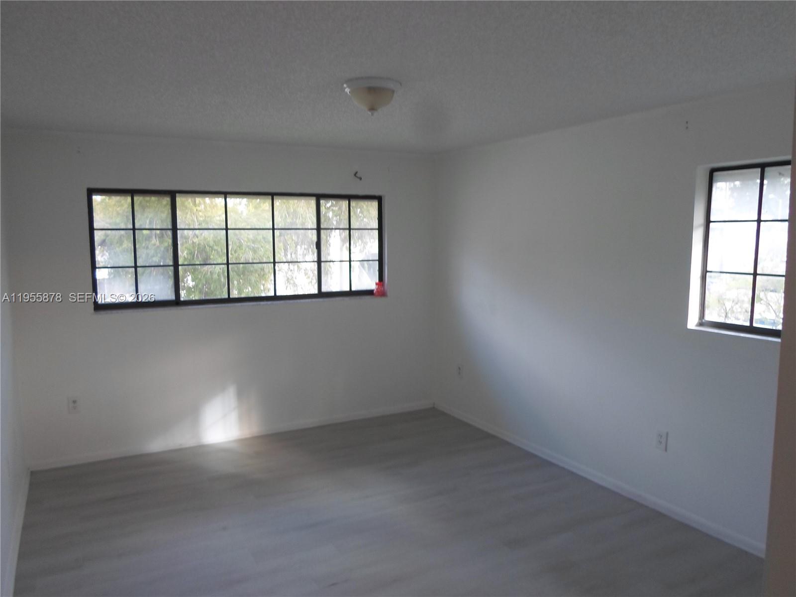 20760 Northeast 4th Court, Unit 201 Miami, FL 33179 - Photo 32 of 55 an empty room with a empty space and windows