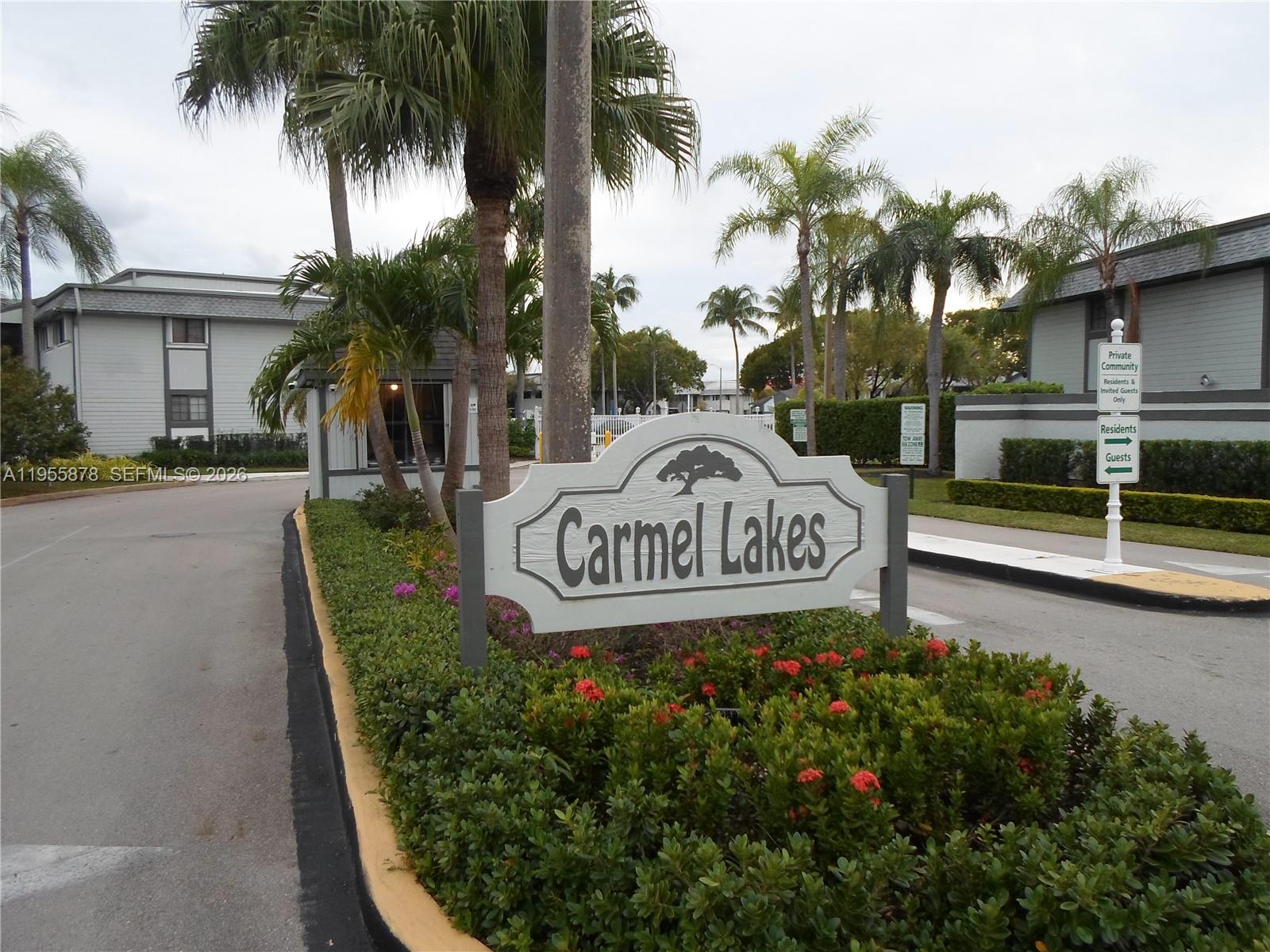 20760 Northeast 4th Court, Unit 201 Miami, FL 33179 - Photo 4 of 55 a view of sign board with yard and palm trees