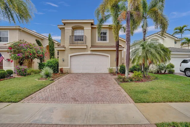 a front view of a house with a yard and a garage
