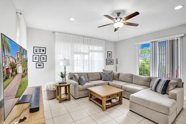 a living room with furniture a rug and white walls