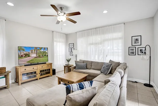 a dining room with furniture a chandelier and window