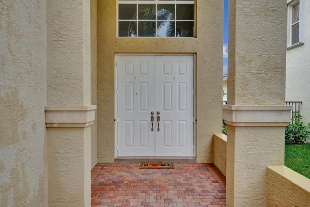 a living room with furniture a mirror and a fireplace