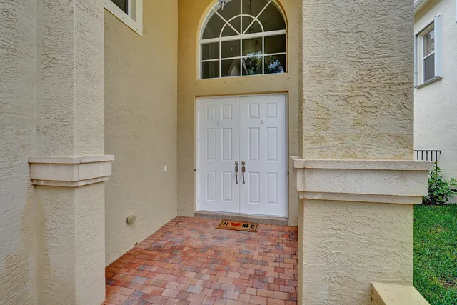 a living room with furniture a rug a clock and a window