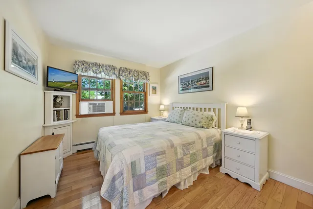 a bedroom with a large bed and a window