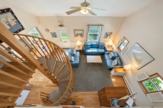 a view of a livingroom with furniture and staircase