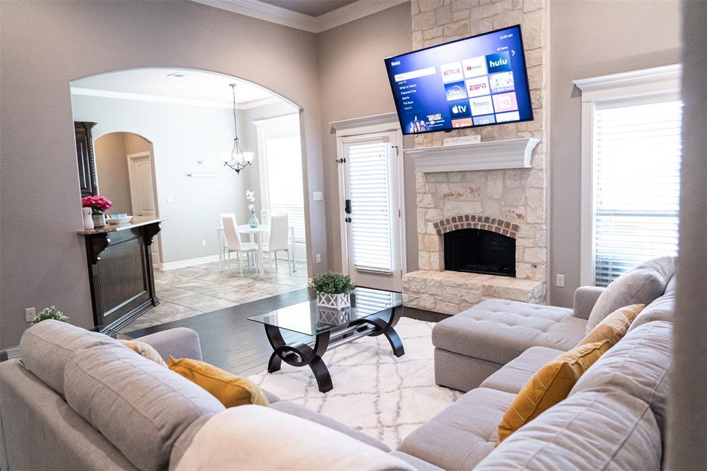 7352 Kingsport Lane Tyler, TX 75703 - Photo 11 of 38 a living room with furniture a flat screen tv and a fireplace