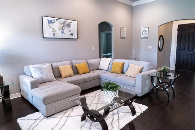 a living room with furniture and wooden floor