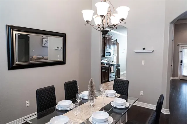 a view of a dining room with furniture wooden floor and a chandelier