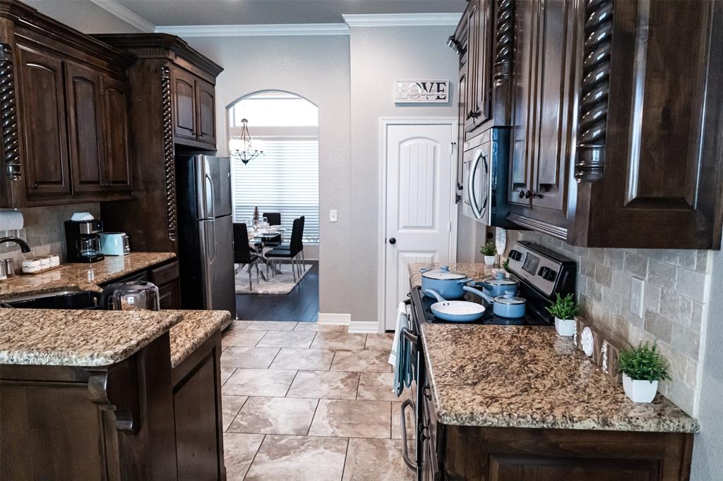 7352 Kingsport Lane Tyler, TX 75703 - Photo 14 of 38 a living room with granite countertop furniture and a fireplace