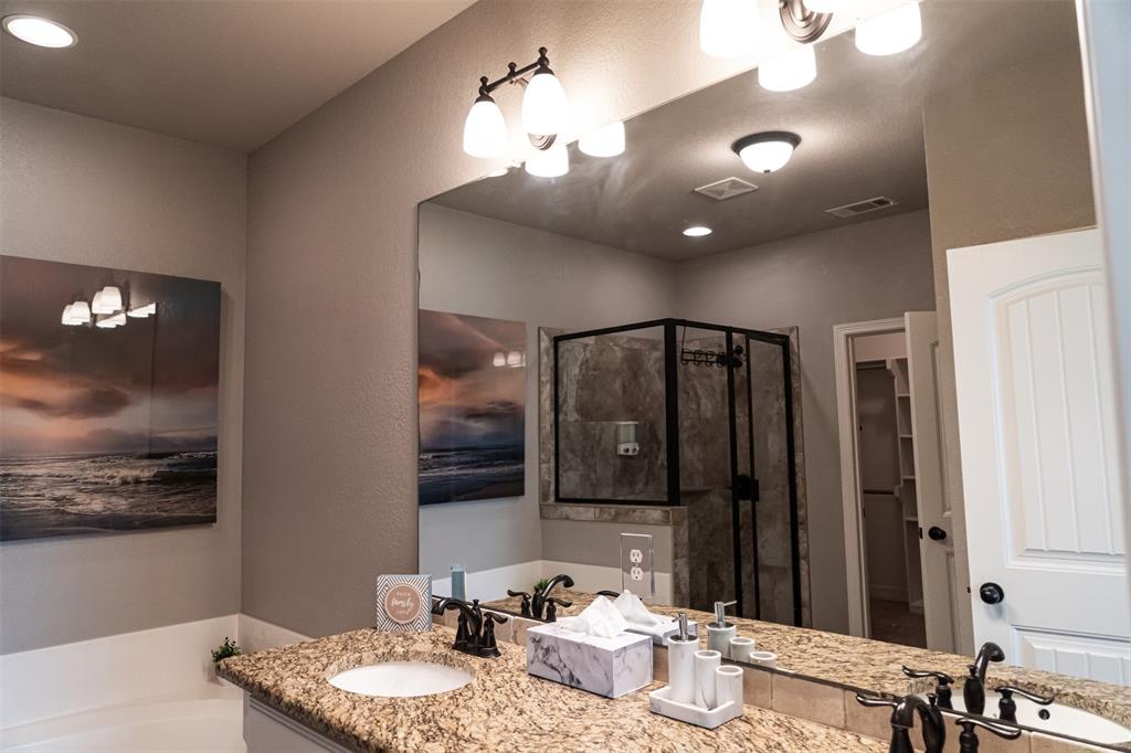7352 Kingsport Lane Tyler, TX 75703 - Photo 19 of 38 a bathroom with a granite countertop double vanity sink and a mirror
