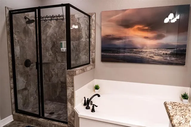 a bathroom with a shower and a bathtub