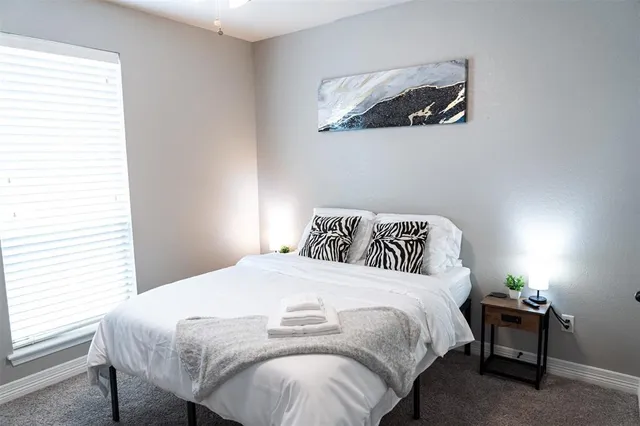 a bedroom with a bed and lamp