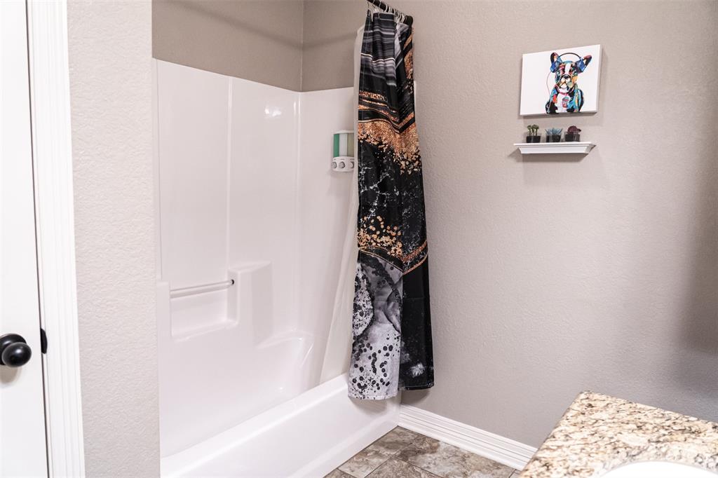 7352 Kingsport Lane Tyler, TX 75703 - Photo 25 of 38 a bathroom with a bathtub and shower