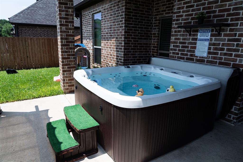 7352 Kingsport Lane Tyler, TX 75703 - Photo 29 of 38 a view of backyard with table and chairs and wooden fence