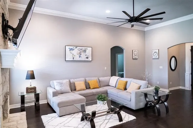 a living room with furniture and wooden floor