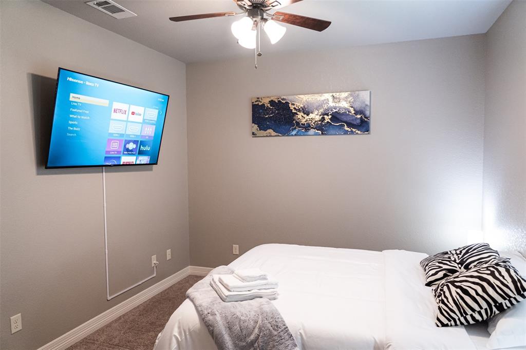 7352 Kingsport Lane Tyler, TX 75703 - Photo 8 of 38 a bedroom with a bed and a painting on the wall