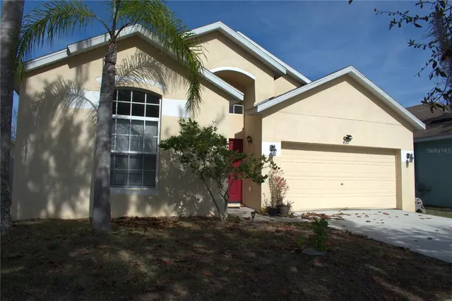 a view of a house with a yard and garage