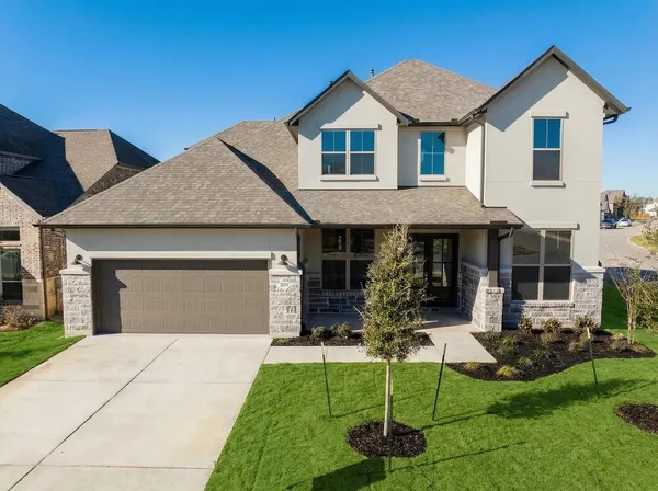 a front view of a house with a yard and porch