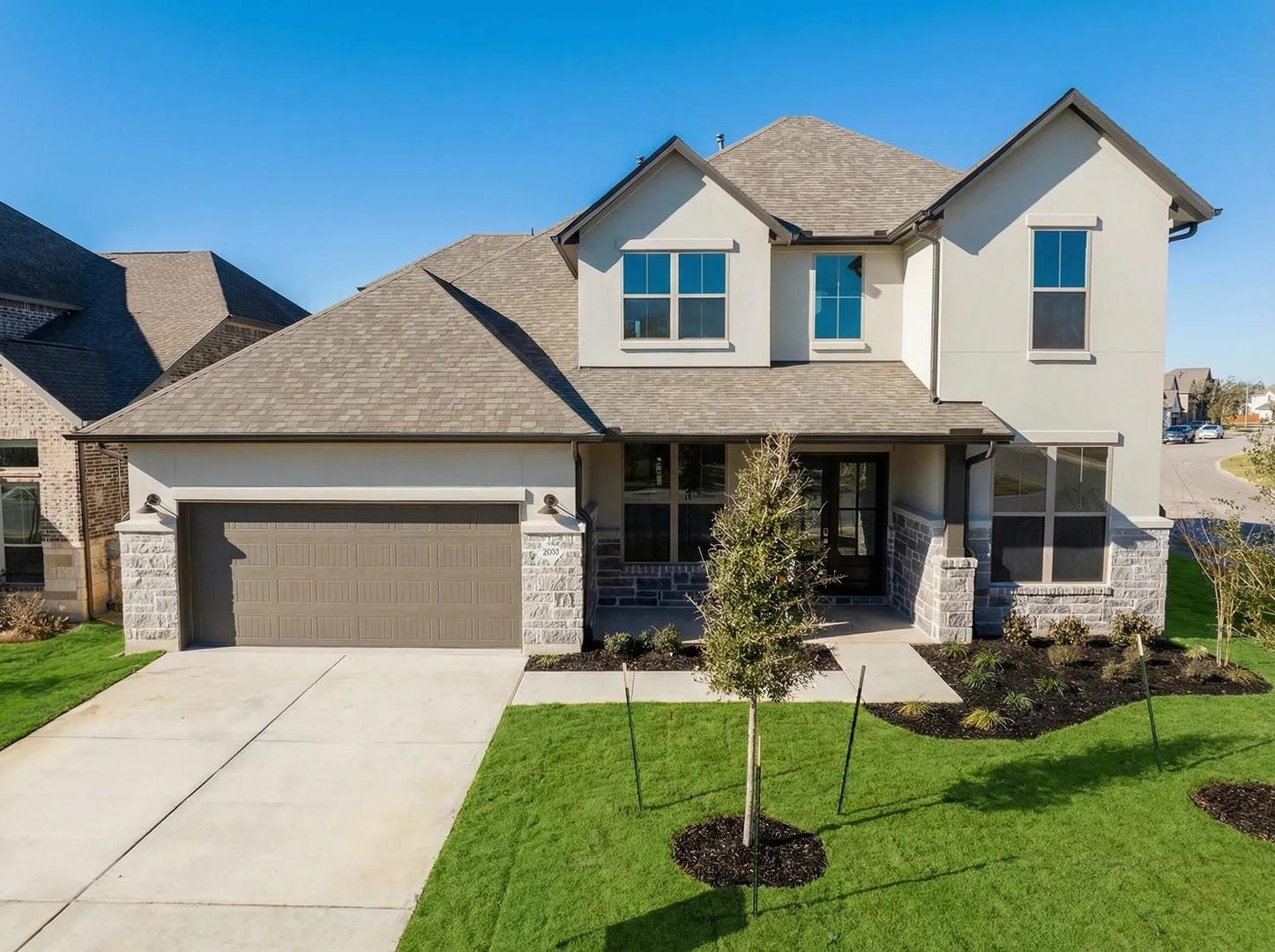 a front view of a house with a yard and porch