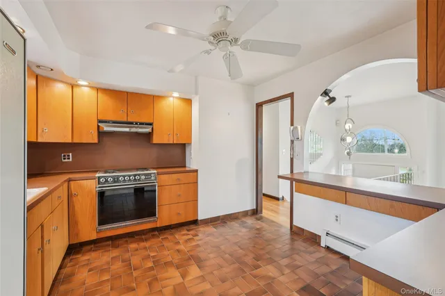 a large kitchen with stainless steel appliances granite countertop a stove and a sink