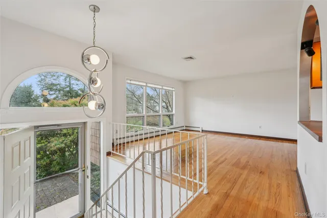 a view of an entryway with wooden floor