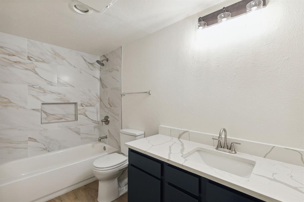 3827 Gilbert Avenue, Unit 214 Dallas, TX 75219 - Photo 11 of 25 a bathroom with a sink a toilet and bathtub