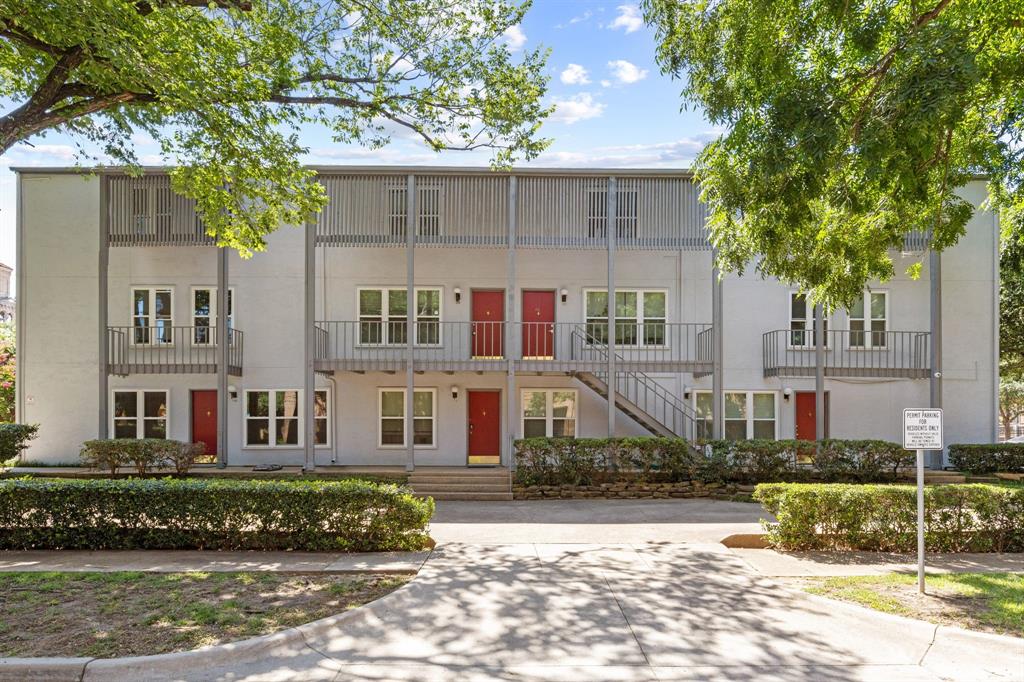3827 Gilbert Avenue, Unit 214 Dallas, TX 75219 - Photo 24 of 25 a view of a white house with a large tree
