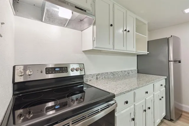 a kitchen with appliances and cabinets