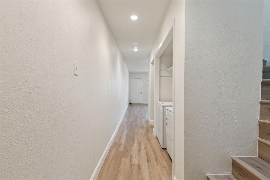 3827 Gilbert Avenue, Unit 214 Dallas, TX 75219 - Photo 10 of 25 a view of a hallway with wooden floor and staircase
