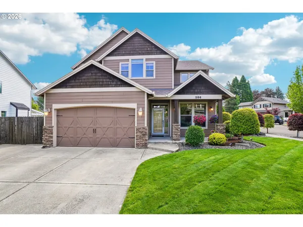 a front view of a house with a yard and garage