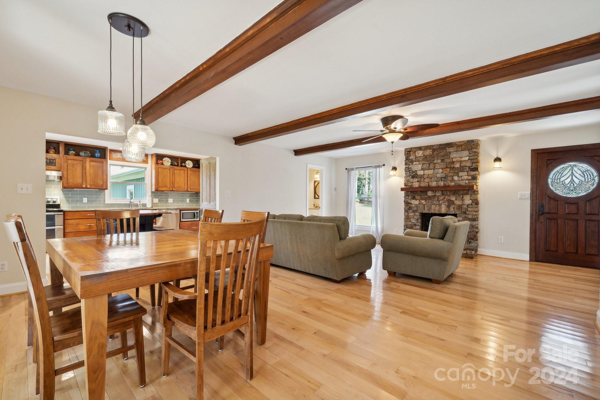 9501 Bartlett Road Mint Hill, NC 28227 - Photo 5 of 46 a view of a dining room and livingroom with furniture wooden floor a chandelier