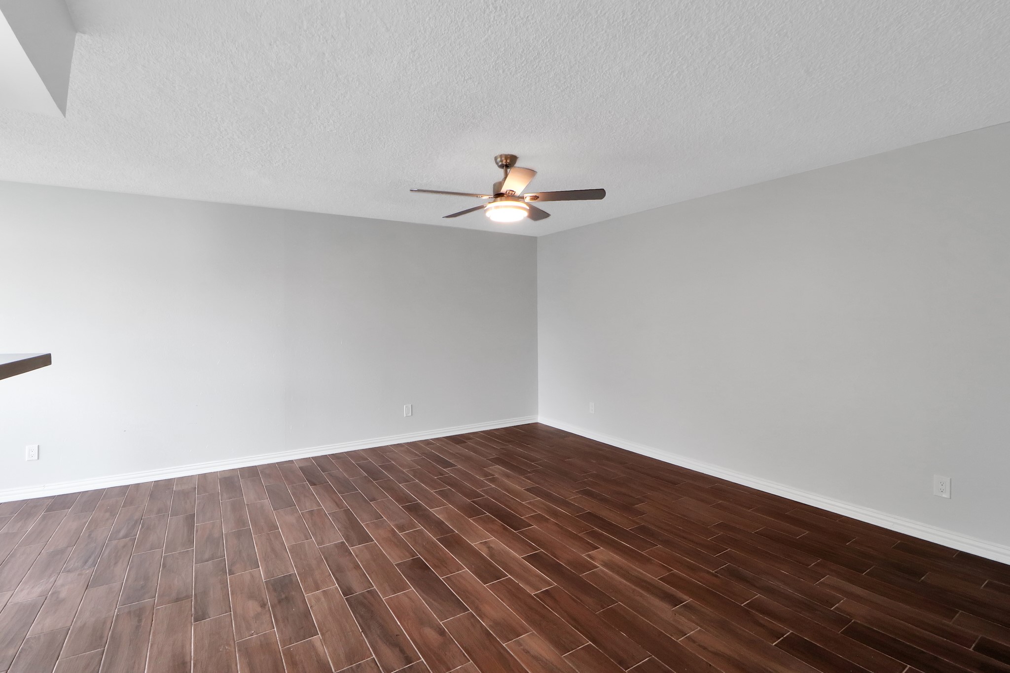 7047 Bissonnet Street, Unit 117 Houston, TX 77074 - Photo 2 of 17 wooden floor in an empty room with a window