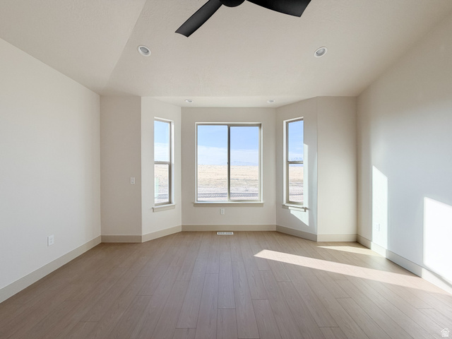 533 West S Temple Street, Unit 309 Tooele, UT 84074 - Photo 12 of 24 Spare room with light wood finished floors, a ceiling fan, and recessed lighting