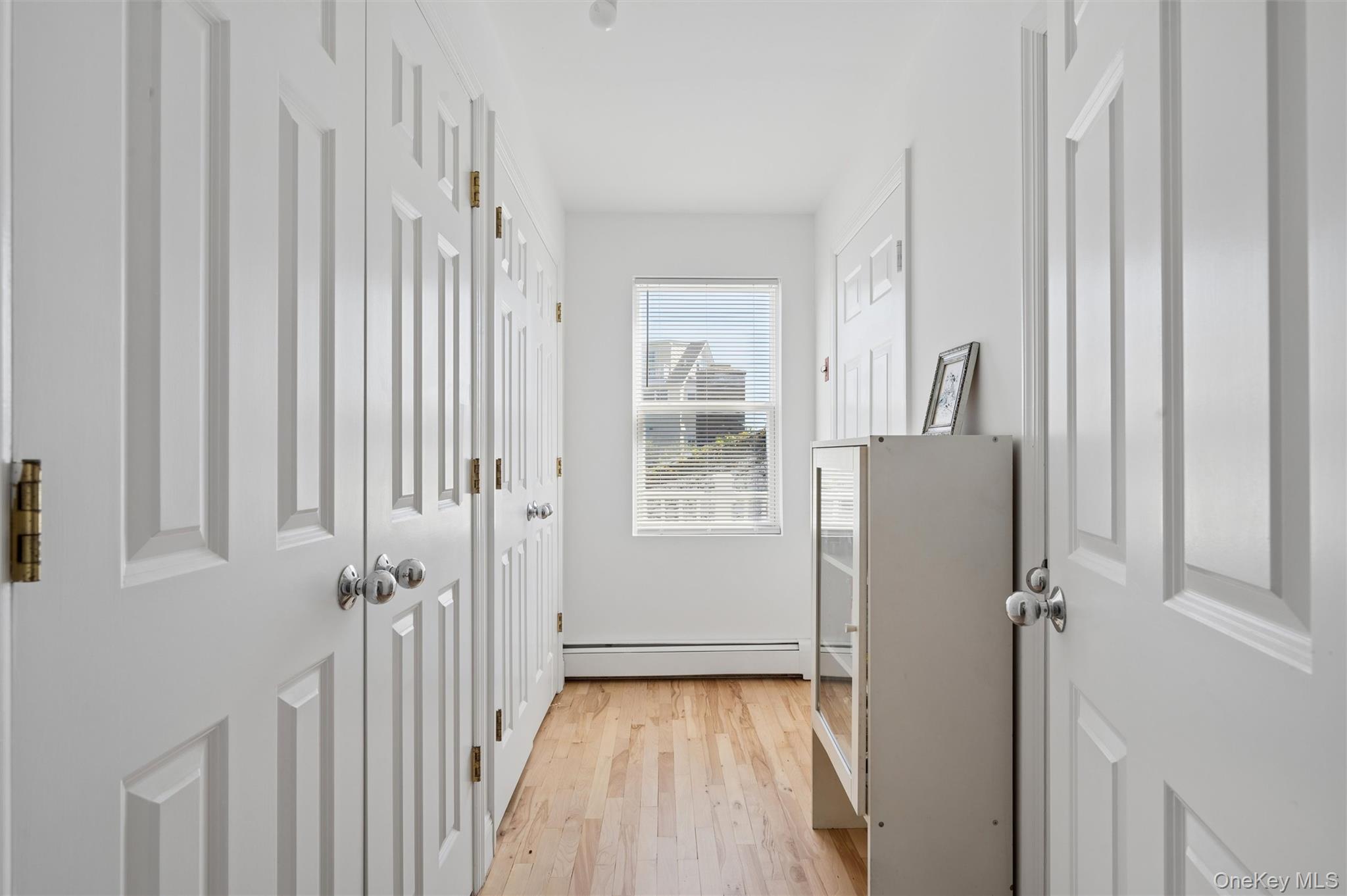 898 Dune Road Westhampton Beach, NY 11978 - Photo 11 of 36 a view of a hallway with wooden floor and entryway