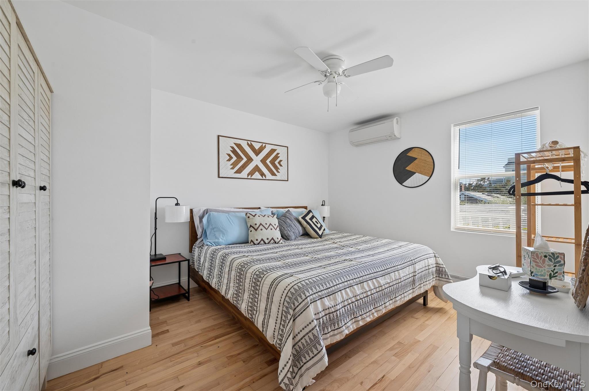 898 Dune Road Westhampton Beach, NY 11978 - Photo 14 of 36 a bedroom with a bed and a table