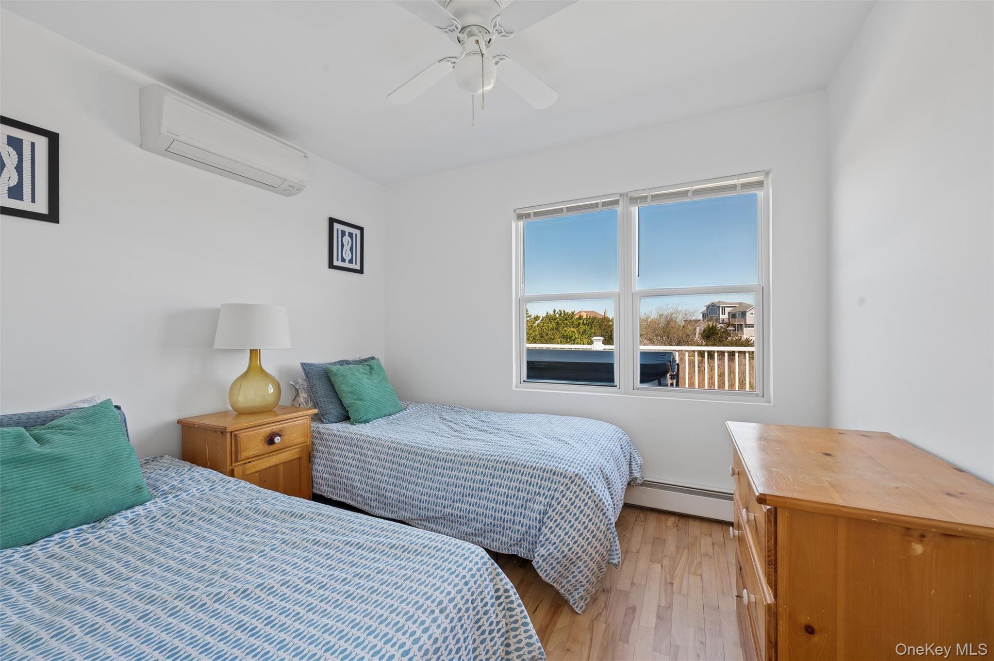 898 Dune Road Westhampton Beach, NY 11978 - Photo 15 of 36 a bedroom with a bed and a cabinets