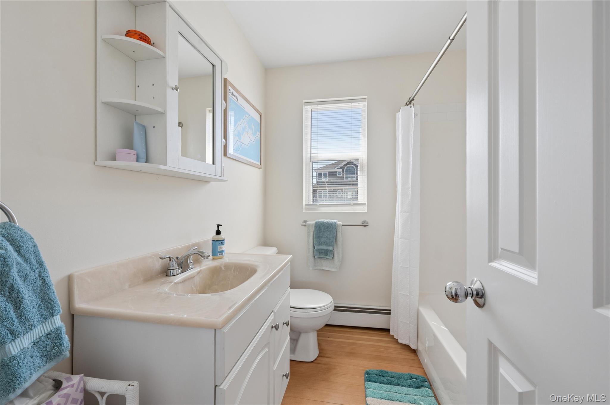 898 Dune Road Westhampton Beach, NY 11978 - Photo 17 of 36 a bathroom with a sink and mirror with toilet