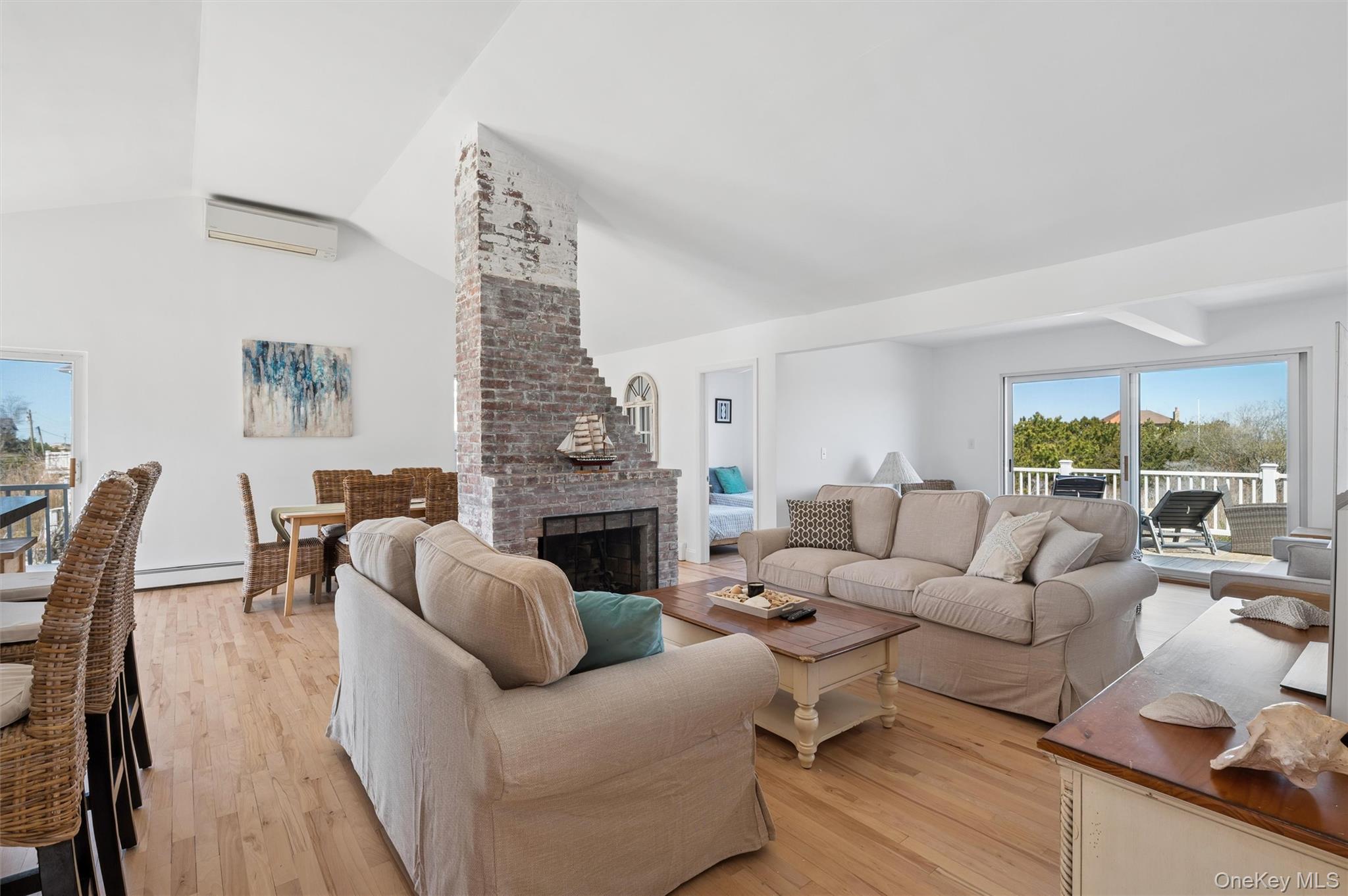 898 Dune Road Westhampton Beach, NY 11978 - Photo 6 of 36 a living room with furniture fireplace and a large window