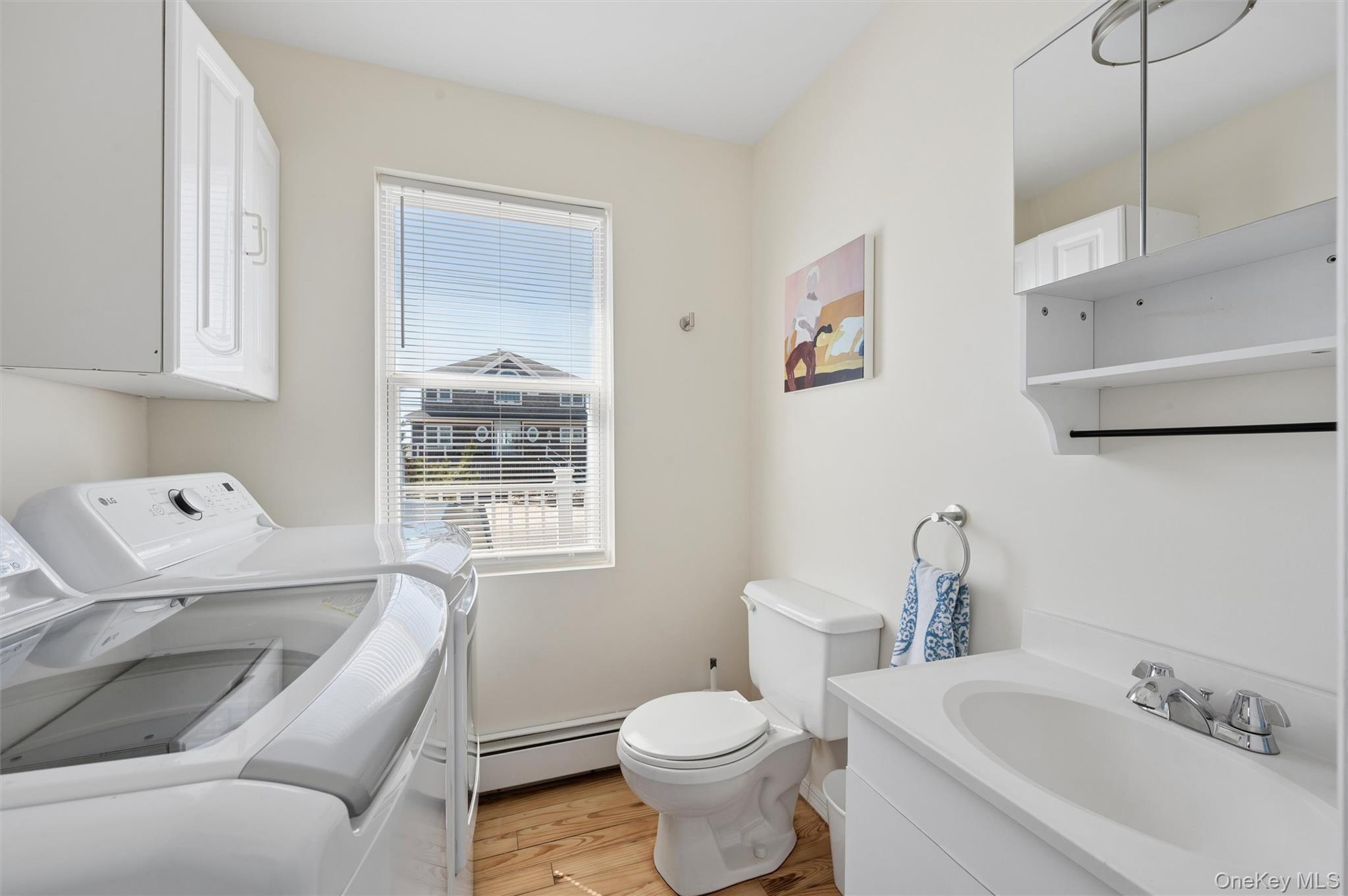 898 Dune Road Westhampton Beach, NY 11978 - Photo 7 of 36 a white toilet sitting next to a bathroom sink