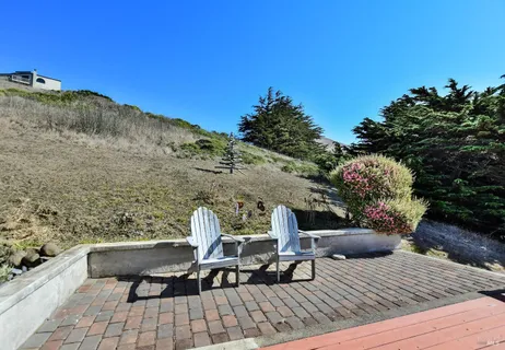 a view of a chairs and table in patio