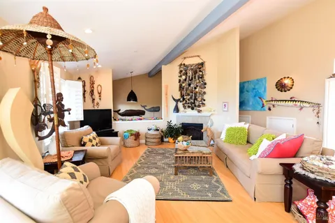 a living room with furniture a rug and white walls