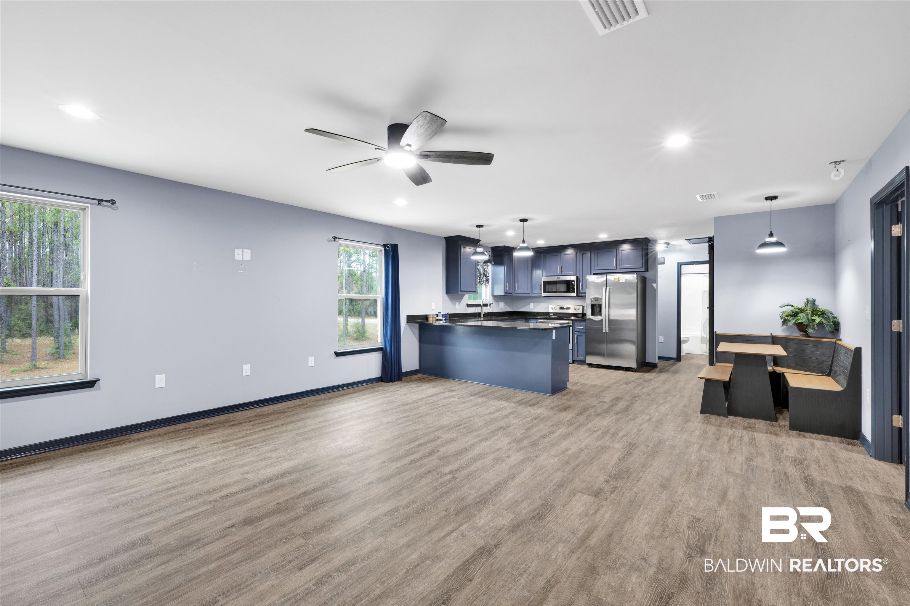 36397 Alexandria Trail Stapleton, AL 36578 - Photo 65 of 65 Kitchen featuring a peninsula, dark countertops, stainless steel appliances, open floor plan, and decorative light fixtures